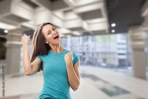 Young female with raised hands celebrating success cheerful positive woman with raised hands