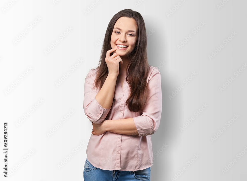 Young happy smiling woman in shirt with crossed arms over background Young happy smiling woman in shirt with crossed arms over background