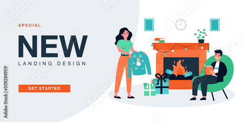 Girlfriend giving Christmas surprise gift to happy boyfriend. Man sitting by fireplace at home flat vector illustration. Celebration, love concept for banner, website design or landing web page