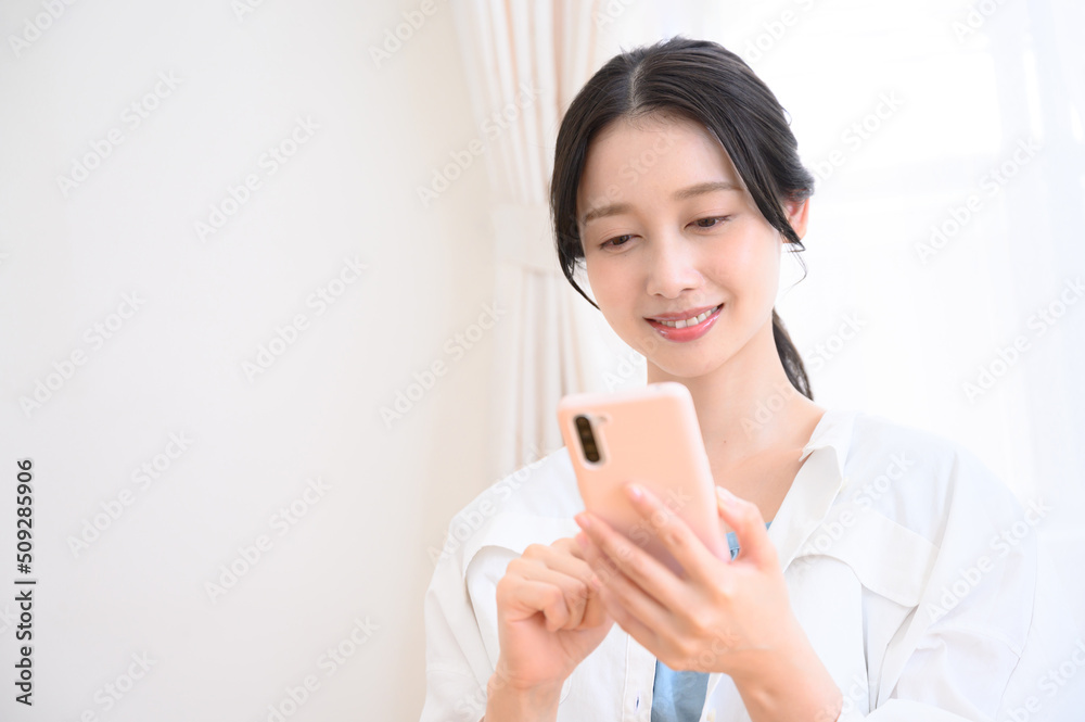 Woman holding and tapping her phone Woman holding and tapping her phone
