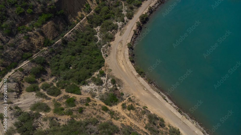 Drone photos of El Morro hill, recorded in the middle of a sunny morning, in the videos you can see, El Morro hill, hills, mountains, coasts, roads, trees on the shore of the beach, beach, rocks, sand