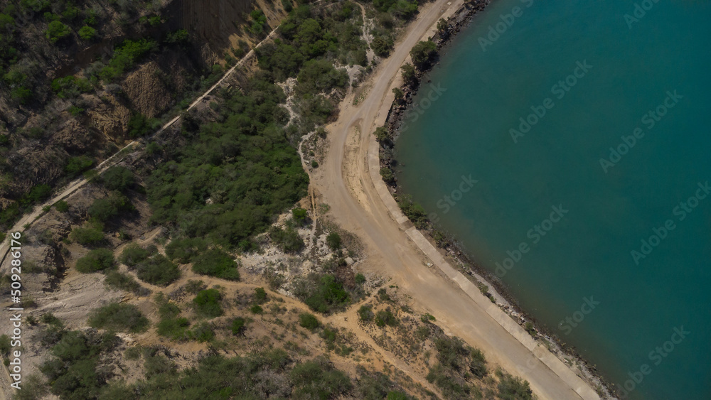 Obraz premium Drone photos of El Morro hill, recorded in the middle of a sunny morning, in the videos you can see, El Morro hill, hills, mountains, coasts, roads, trees on the shore of the beach, beach, rocks, sand