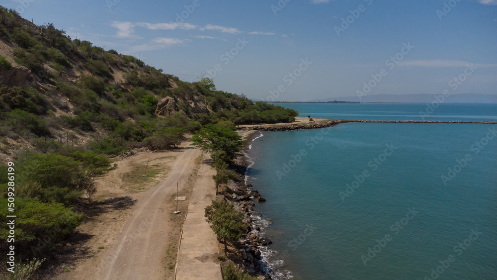 Drone photos of El Morro hill, recorded in the middle of a sunny morning, in the videos you can see, El Morro hill, hills, mountains, coasts, roads, trees on the shore of the beach, beach, rocks, sand Drone photos of El Morro hill, recorded in the middle of a sunny morning, in the videos you can see, El Morro hill, hills, mountains, coasts, roads, trees on the shore of the beach, beach, rocks, sand