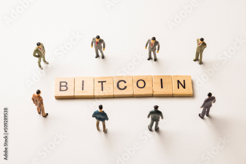 businessman figures at bitcoin words