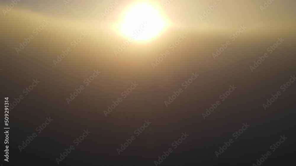 Aerial shot of the sunrise above a layer of clouds Aerial shot of the sunrise above a layer of clouds