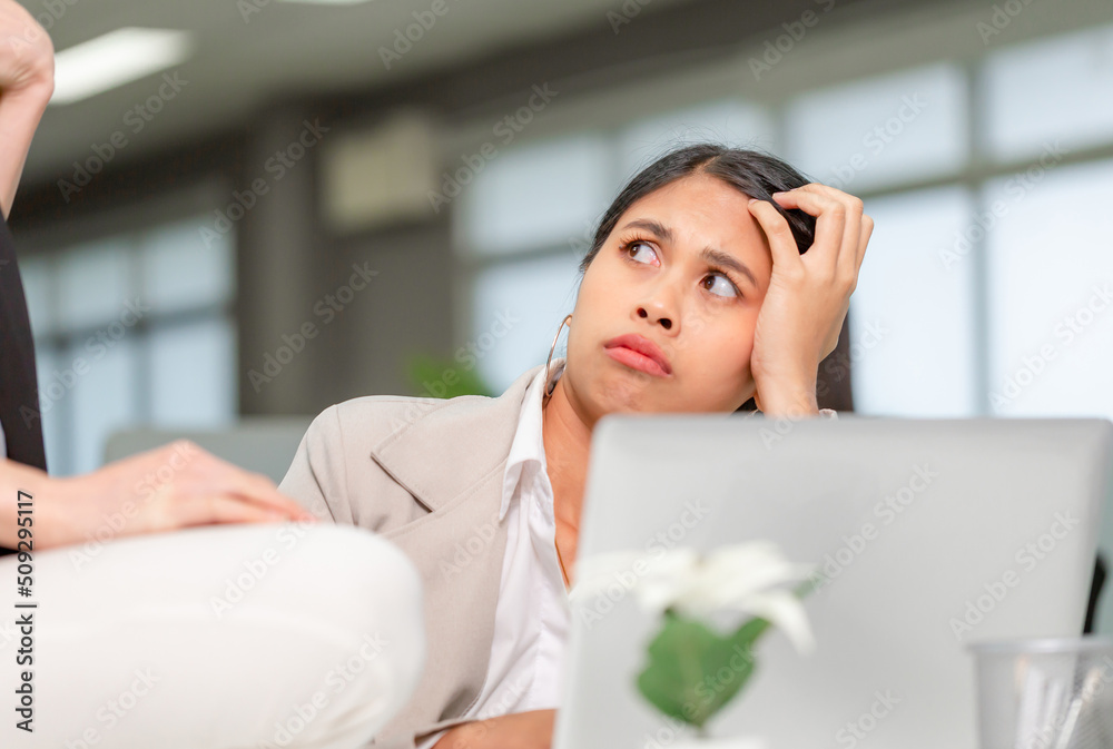 Portrait of Woman looking at her coworker with a displeased expression, woman working in her office Portrait of Woman looking at her coworker with a displeased expression, woman working in her office