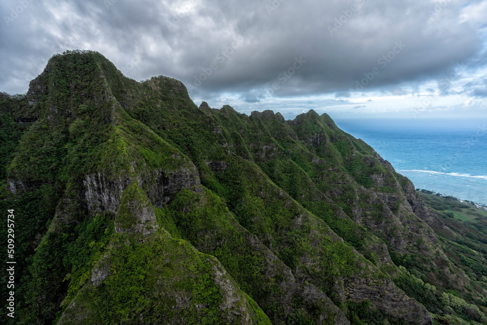 Soaring mountainous peaks leading to deep valley with clouds, Oahu Island, Hawaii