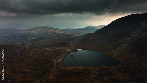 Lough Barfinnihy, Killarney, Kerry, Ireland, March 2022. Drone pulls north away from the lake under a moody sky with views south towards Greenane and the Macgillycuddy's Reeks mountains. photo