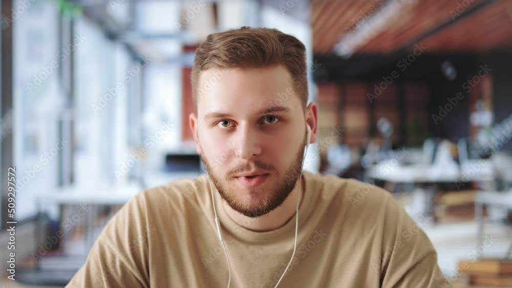 First person view of young caucasian product manager talking with qualified team during video call. Communicative man sitting at workplace of modern coworking space. First person view of young caucasian product manager talking with qualified team during video call. Communicative man sitting at workplace of modern coworking space.