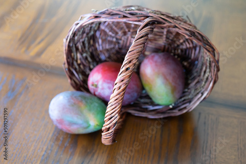 Organic Fresh Red Mangoes ready to eat in a basket photo