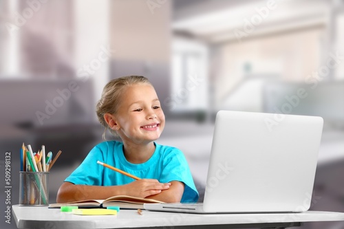 Portrait of smiling child studying at home, homeschooling concept