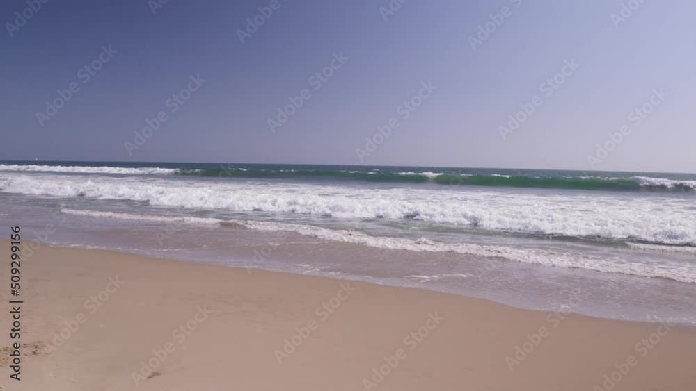 Panning shot from persons perspective showing waves crashing onto the shore in Santa Monica, CA. Panning shot from persons perspective showing waves crashing onto the shore in Santa Monica, CA.