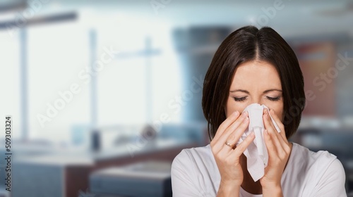 Allergy Season, girl blows in a napkin his nose on natural background
