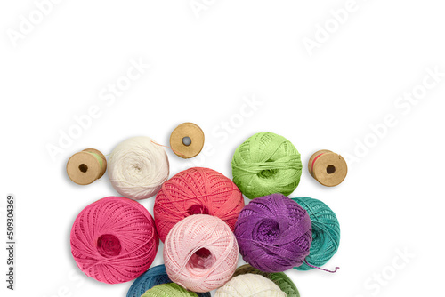 Balls of wool yarn with wooden bobbin with threads on white isolated background. Concept of knitting, sewing. Copy space