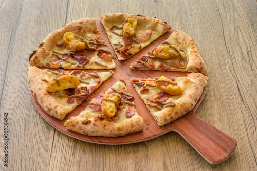 pizza with corqueta on a wood table