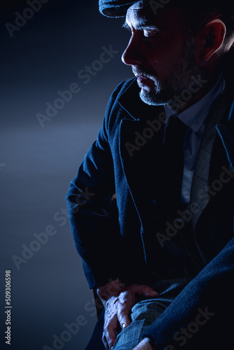 Portrait of a businessman 40-50 years old in the studio. Portrait on a blue background.