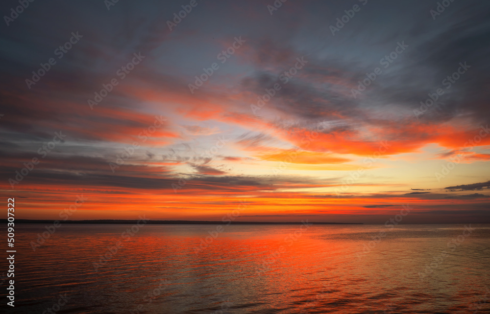 Dramatic sunset sky with clouds. Breathtaking sunset over the sea