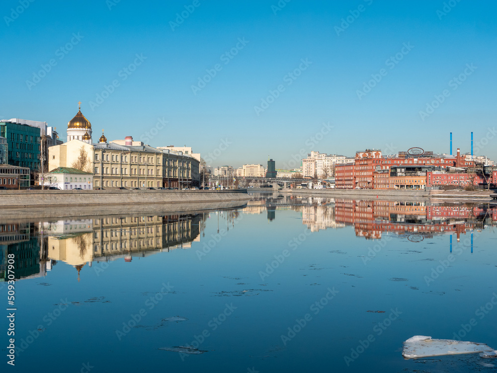 Moscow, Russia - March 01, 2022: Beautiful view of the embankment of the Muzeon Park, the Cathedral of Christ the Savior and the Red October factory building against the blue sky. Copy space