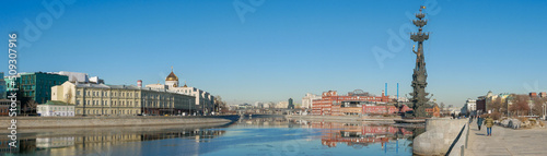 Moscow, Russia - March 01, 2022: Beautiful panoramic view of the embankment of the Muzeon Park against the blue sky. People walk along the Moscow River on a sunny spring day