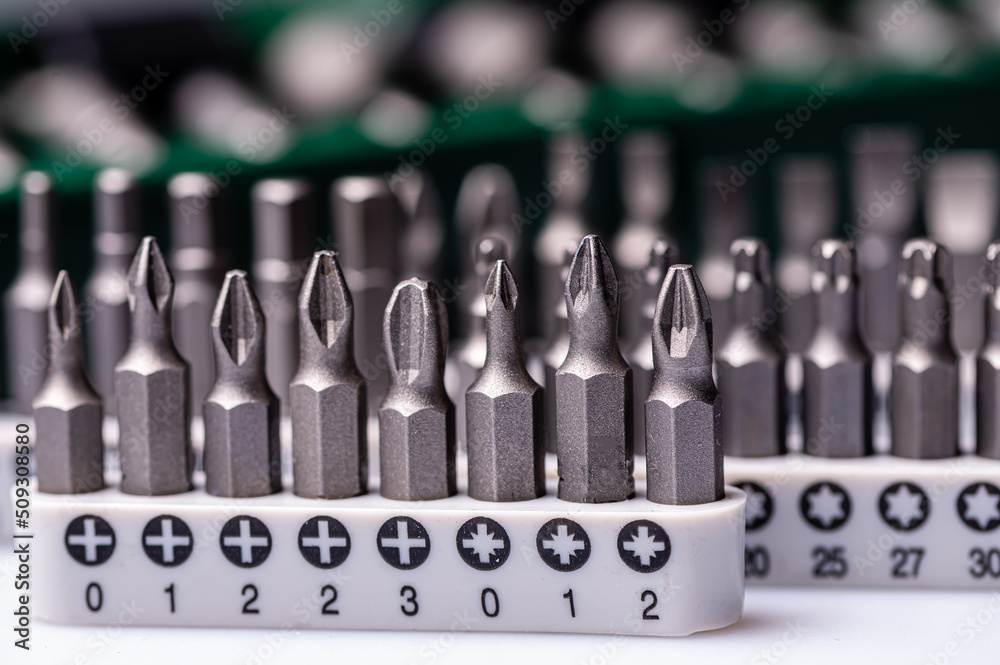 Interchangeable screwdriver bit set, isolated on white, selective focus, dof, closeup Interchangeable screwdriver bit set, isolated on white, selective focus, dof, closeup