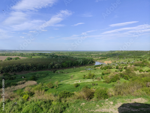 Summer valley with river, forest, hills and beautiful sky with clouds