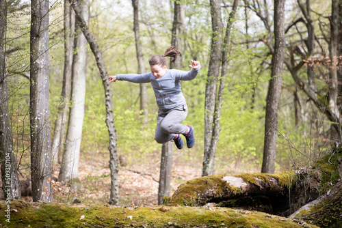 Girl jumping in the woods