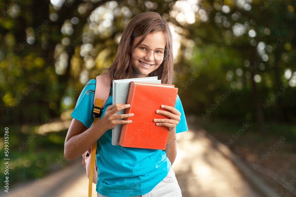 Smiling little kid with backpack hold books Smiling little kid with backpack hold books