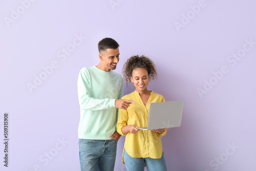 Young couple using laptop o...