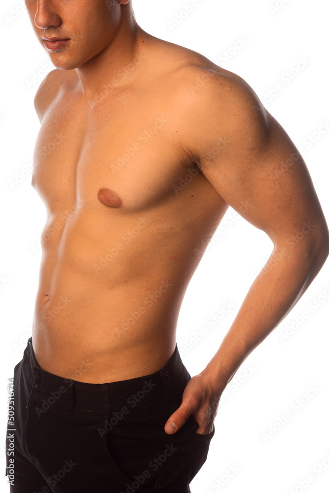 Portrait of a shirtless muscular man standing over white background