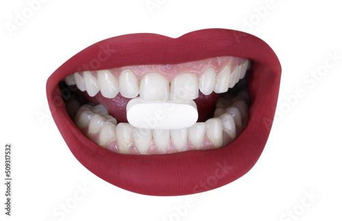 Cutout of womans lips with pill