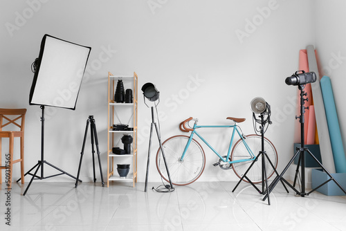 Lighting equipment and bicycle in modern photo studio photo