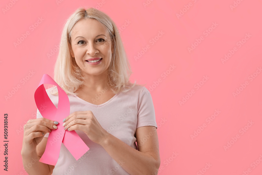 Mature woman with pink ribbon on color background. Breast cancer awareness concept Mature woman with pink ribbon on color background. Breast cancer awareness concept