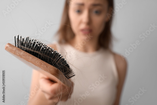 Young woman with hair loss ...