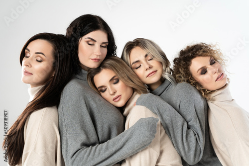 Group of different women wearing turtleneck jumpers on gray background