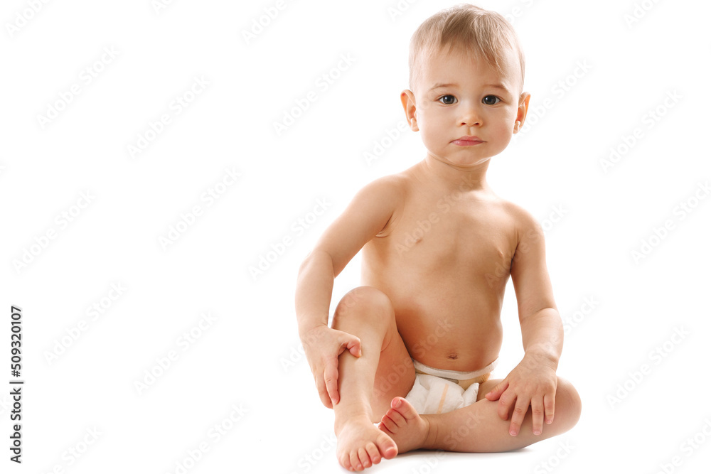 Curious healthy little boy in diaper sitting and looking. Curious healthy little boy in diaper sitting and looking.