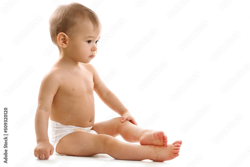 Curious healthy little boy in diaper sitting and looking. Curious healthy little boy in diaper sitting and looking.
