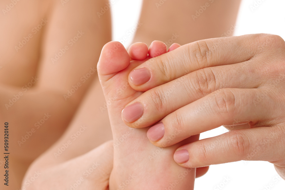 Mother massaging little child's feet and soles. Mother massaging little child's feet and soles.