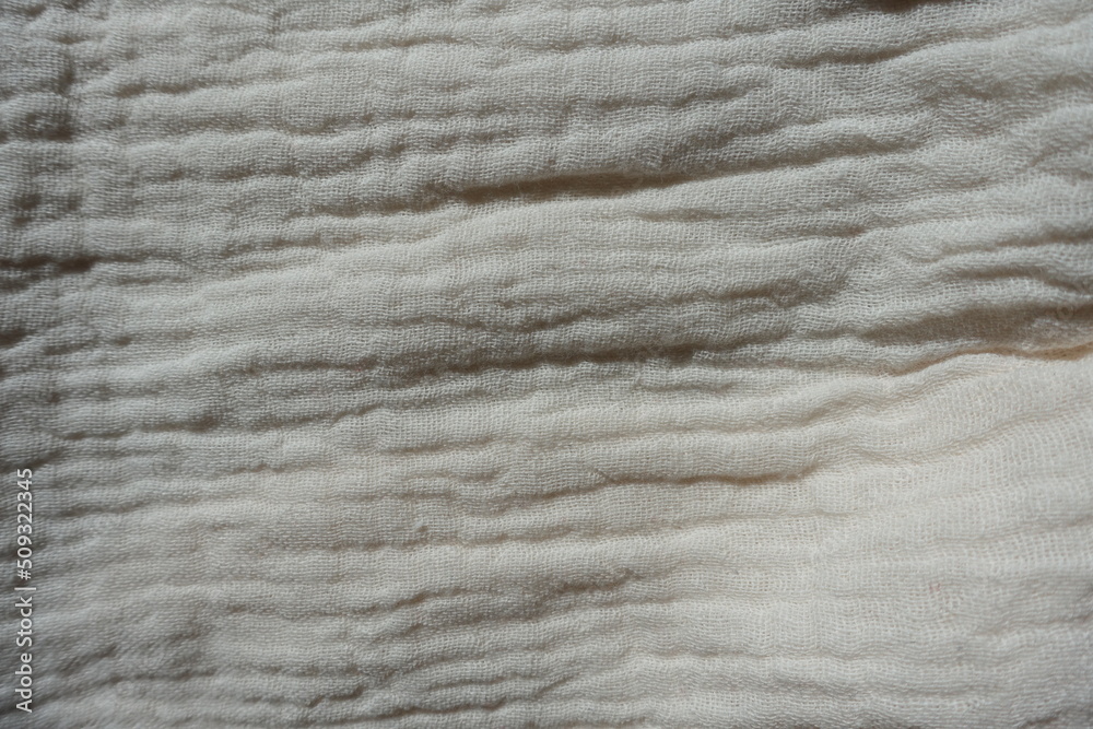 View of simple white cotton muslin fabric from above View of simple white cotton muslin fabric from above