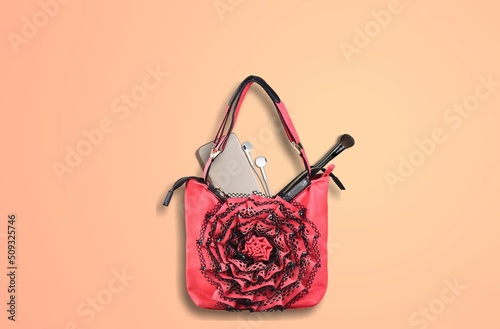 Stylish women's bag and different stuff on background, top view