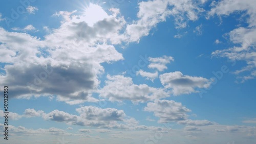 Summer blue sky with fluffy white clouds. White clouds float across the blue sky. photo