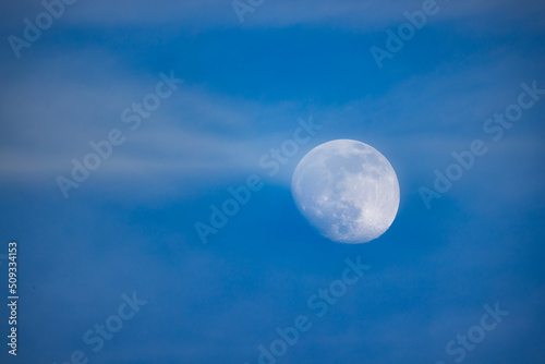 Night sky with full bright moon in the clouds . High quality photo