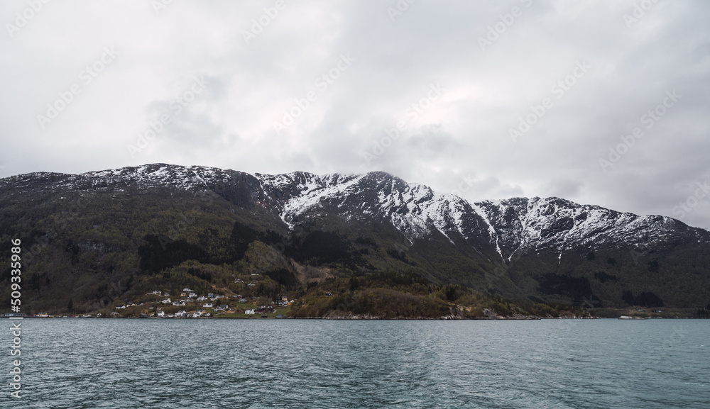 view of a snow mountain at fjord level in Norway.