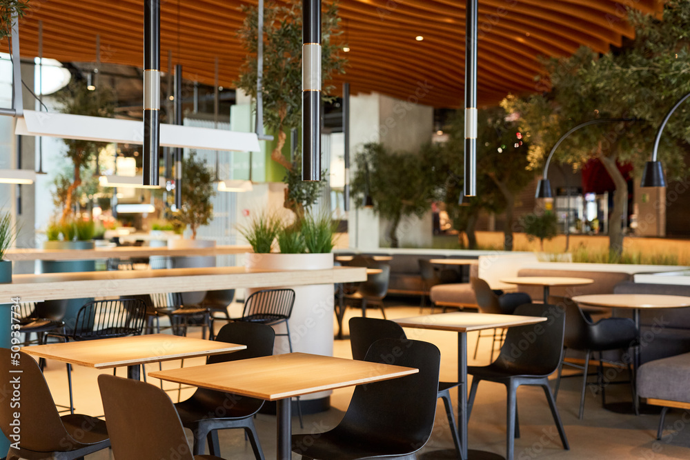 Background image of empty food court interior with wooden tables and warm cozy light setting, copy space