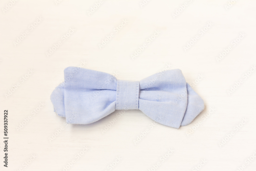 A blue bow tie on white background. Festive, elegant clothing A blue bow tie on white background. Festive, elegant clothing