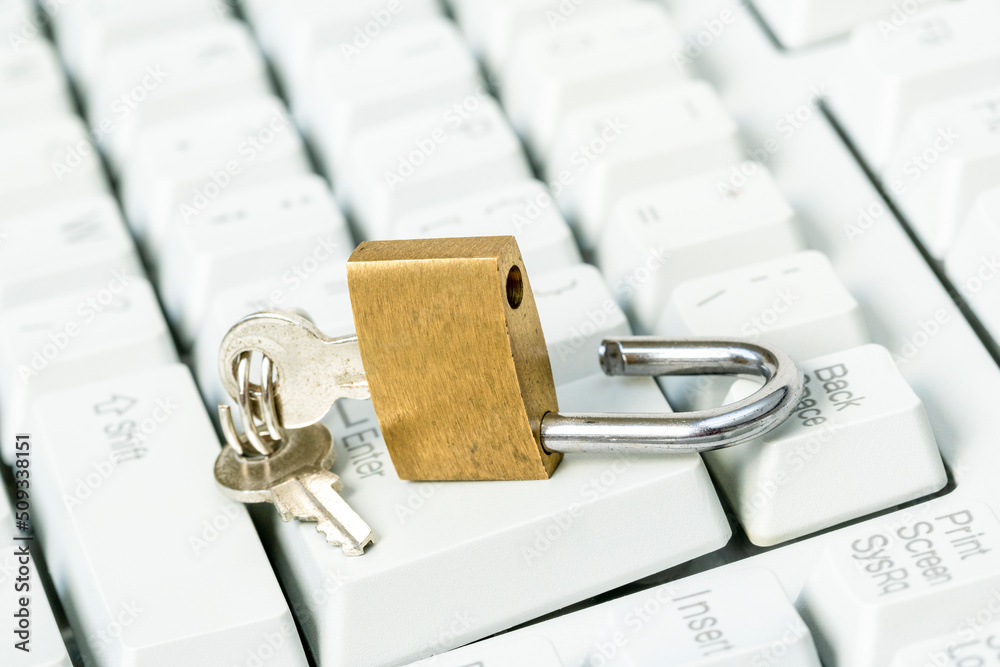 An unlocked padlock on top a computer keyboard An unlocked padlock on top a computer keyboard