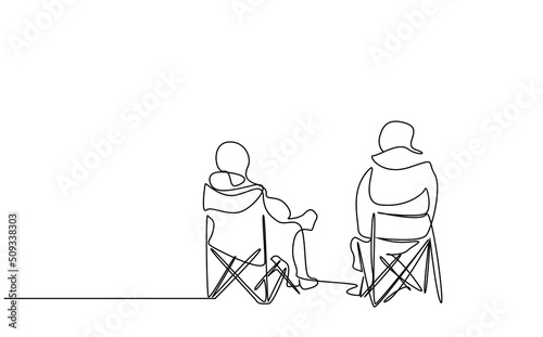 two people sitting calmly on camping chair in nature