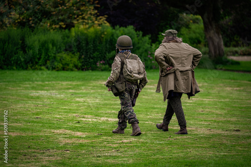 Boy in US army uniform with mum