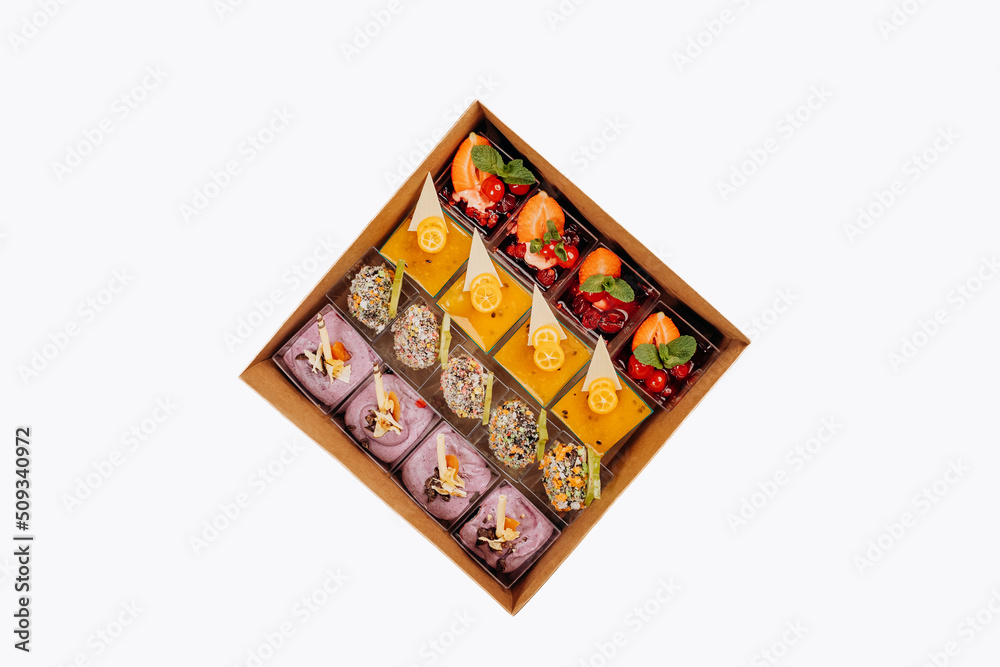 Different portions of desserts with jelly and fruit in a box are ready for delivery Different portions of desserts with jelly and fruit in a box are ready for delivery