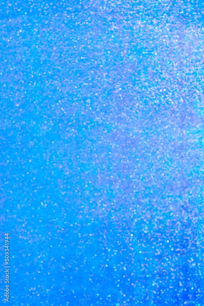 Defocused surface of wrapping film with bokeh effect in blue, lilac and purple