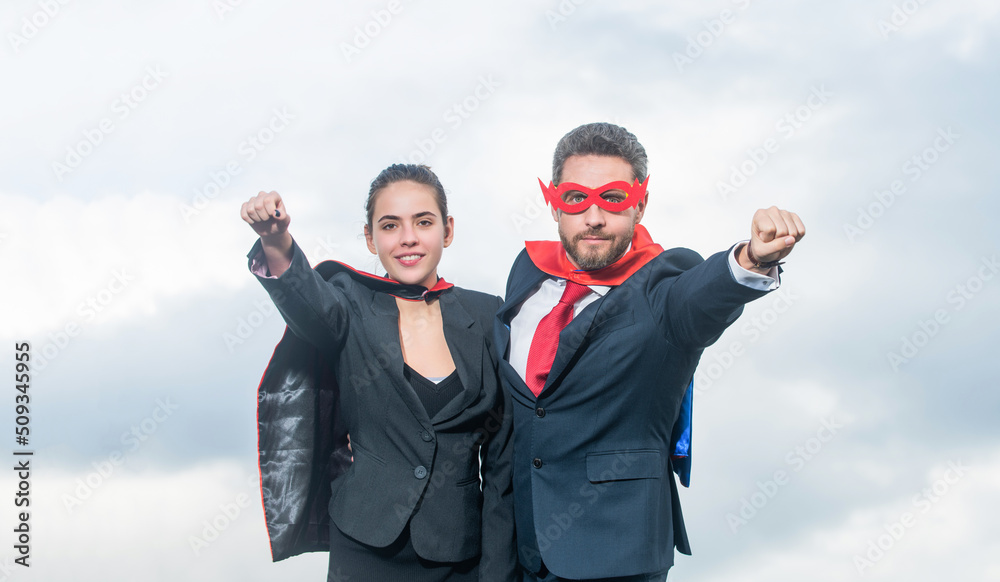 smiling business couple in superhero suit on sky background smiling business couple in superhero suit on sky background